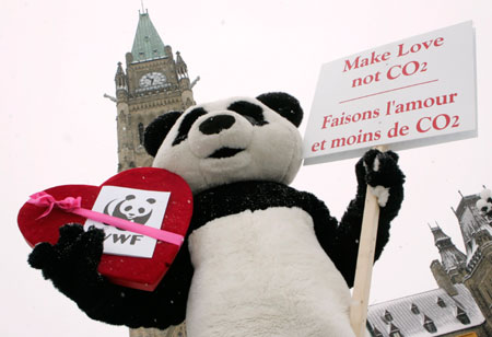 A protester from the World Wildlife Fund dressed in a panda costume demonstrates in front of Parliament Hill in Ottawa February 14, 2007. Canada's House of Commons will vote later Wednesday on a private members' bill designed to force the minority Conservative government to achieve the steep cuts in greenhouse gas emissions required by the Kyoto Protocol on climate change.