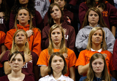 Students place their hands on their hearts during a convocation a day after killings at Virginia Tech in Blacksburg, Virginia, April 17, 2007. Virginia Tech student Cho Seung-hui from South Korea was identified on Tuesday as the gunman who killed 32 people at the university in the deadliest shooting rampage in modern U.S. history.