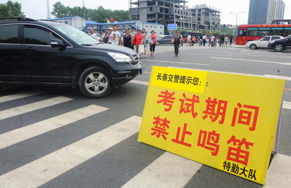 A sign reading, “No whistles during examination,” is placed near a test site in Changchun, June 7, 2013. Big exam day kicks off